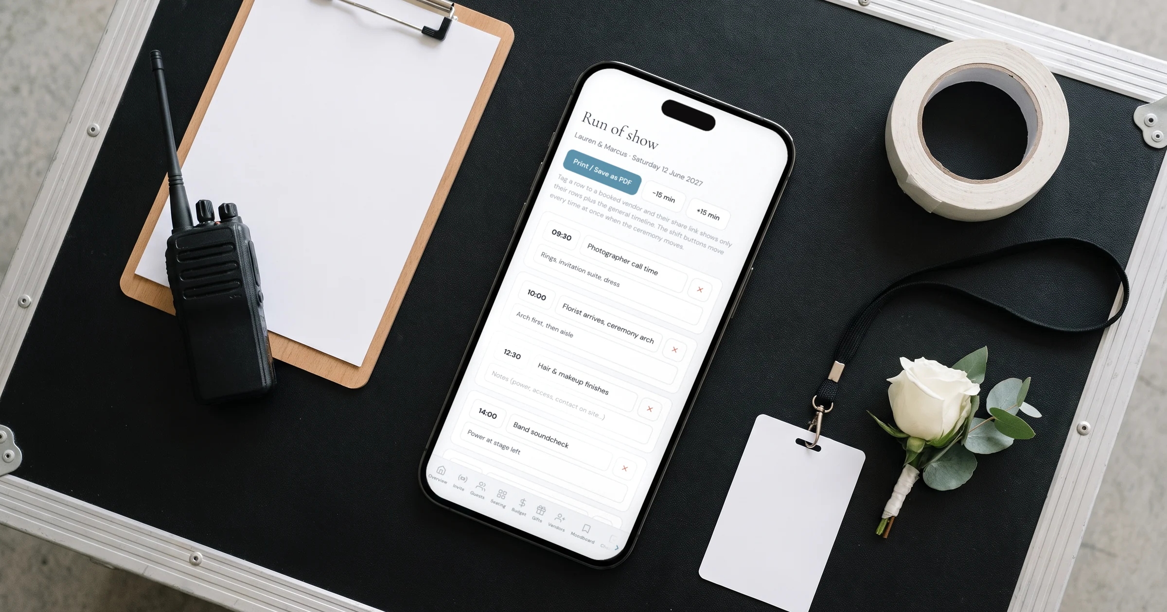 Wedding day timeline template: a phone shows a run of show with vendor call times next to a clipboard and walkie-talkie